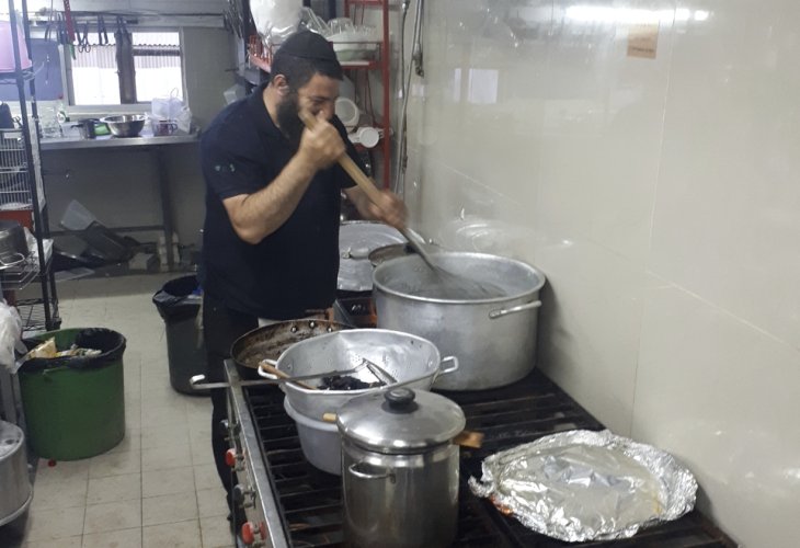 Yosef Chaim cooking in the kitchen