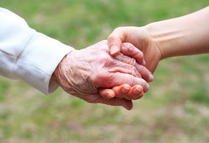Illustration: An elderly hand on the left and a young hand on the right