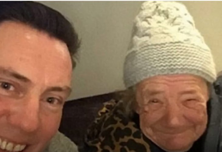 Pictured: The elderly woman with one of the young men