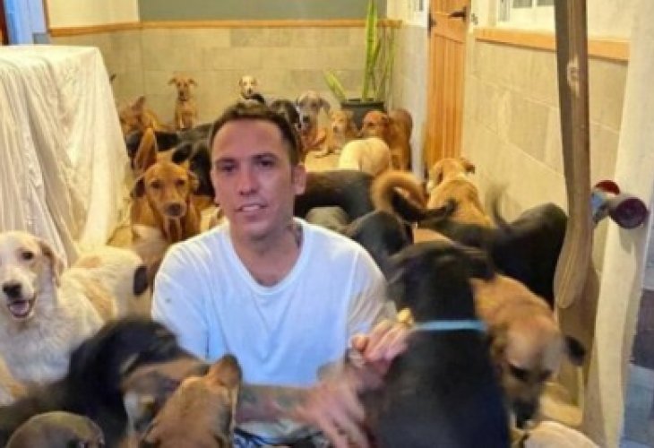Ricardo Pimentel with some of the dogs he sheltered in his home. Ricardo Pimentel with some of the dogs he sheltered in his home.