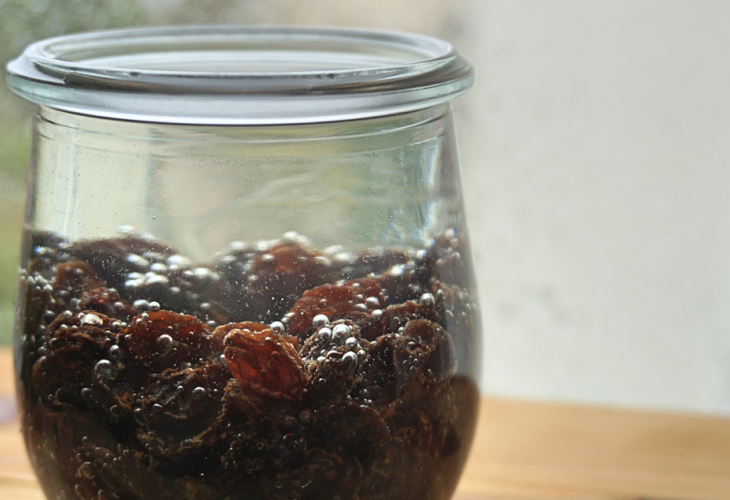 Glass of raisin water on a table Glass of raisin water on a table
