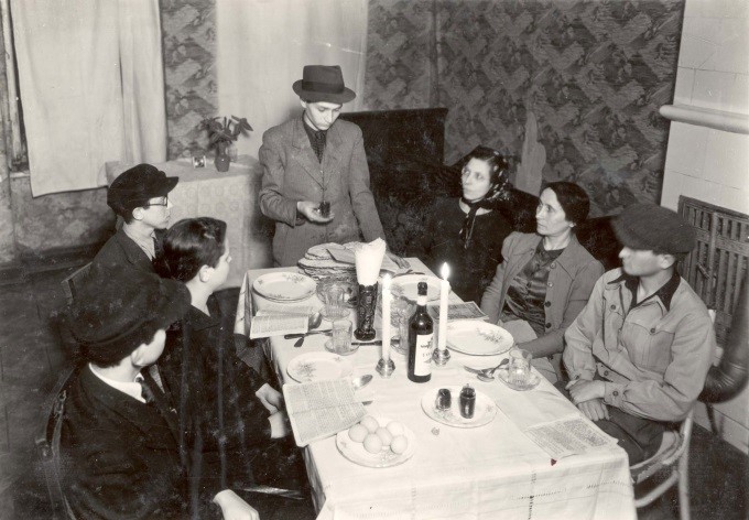 A man recites a blessing over a cup of wine at a Passover Seder in the Warsaw Ghetto