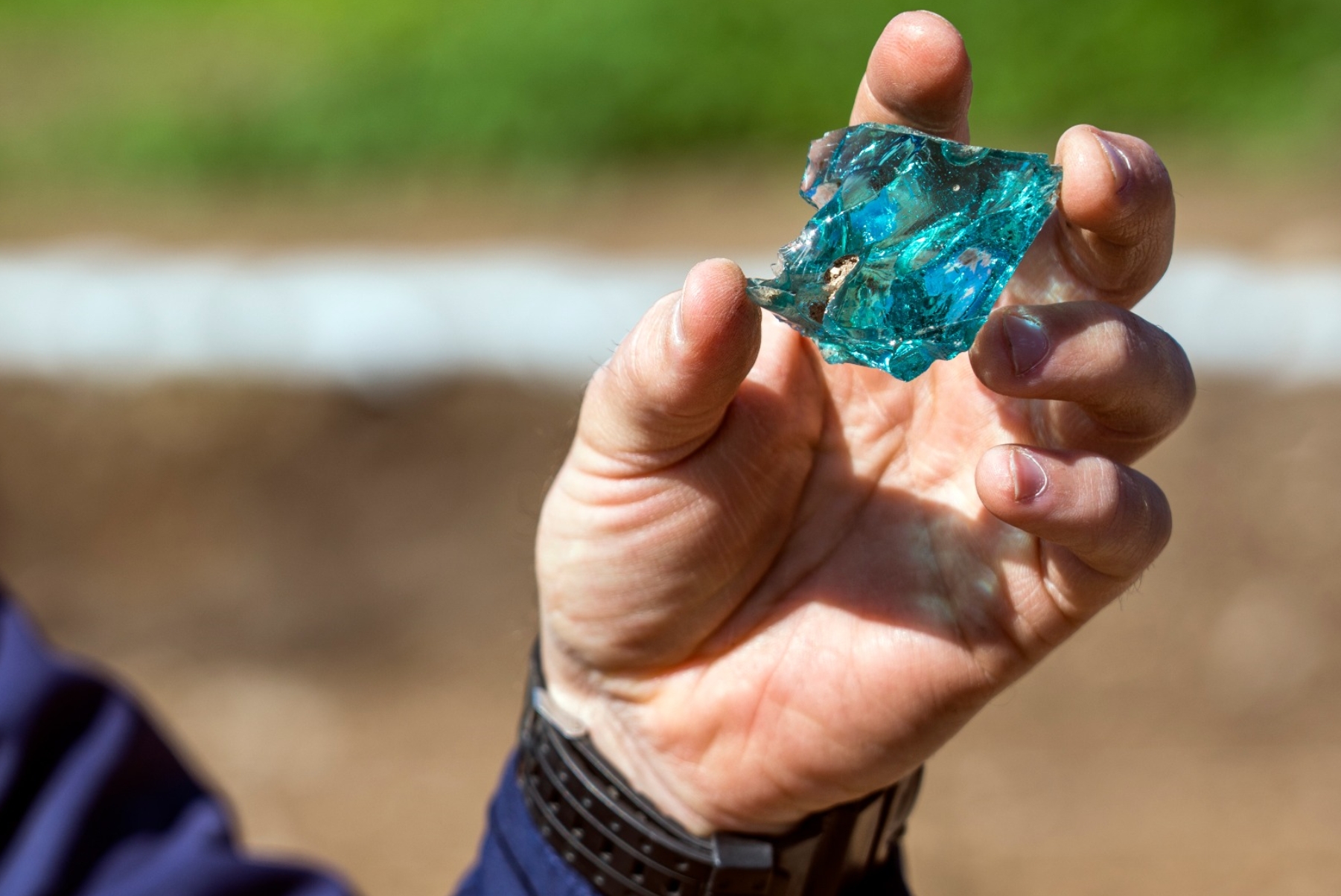 Raw glass fragment uncovered at Usha (Photo: Yaniv Berman, Israel Antiquities Authority)
