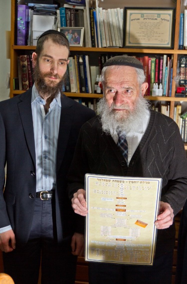 Rabbi Doron holds a family tree from Adam to his family members