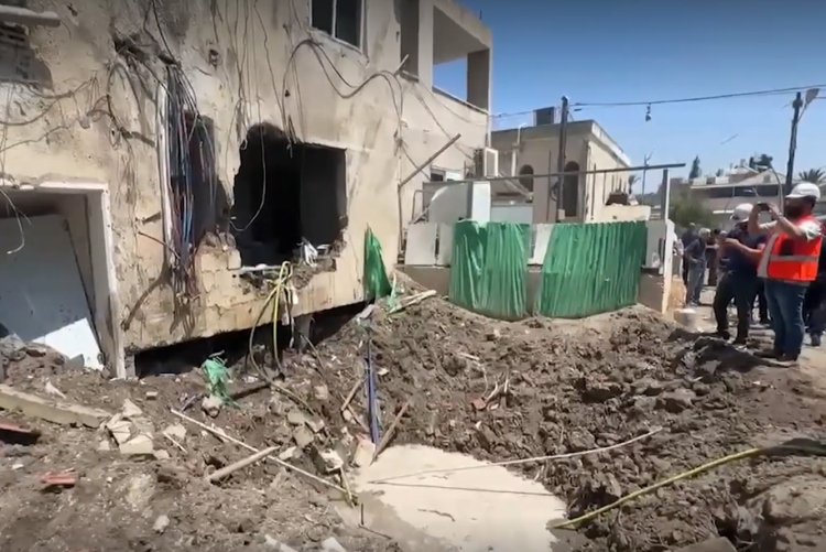 The crater left by the missile strike at the apartment entrance