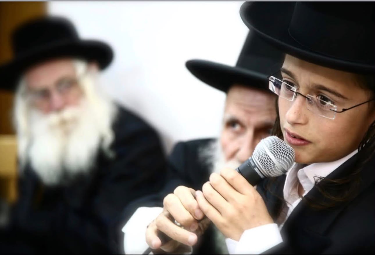 הילד יהונתן בבר המצווה שלו, כשהרב לצדו